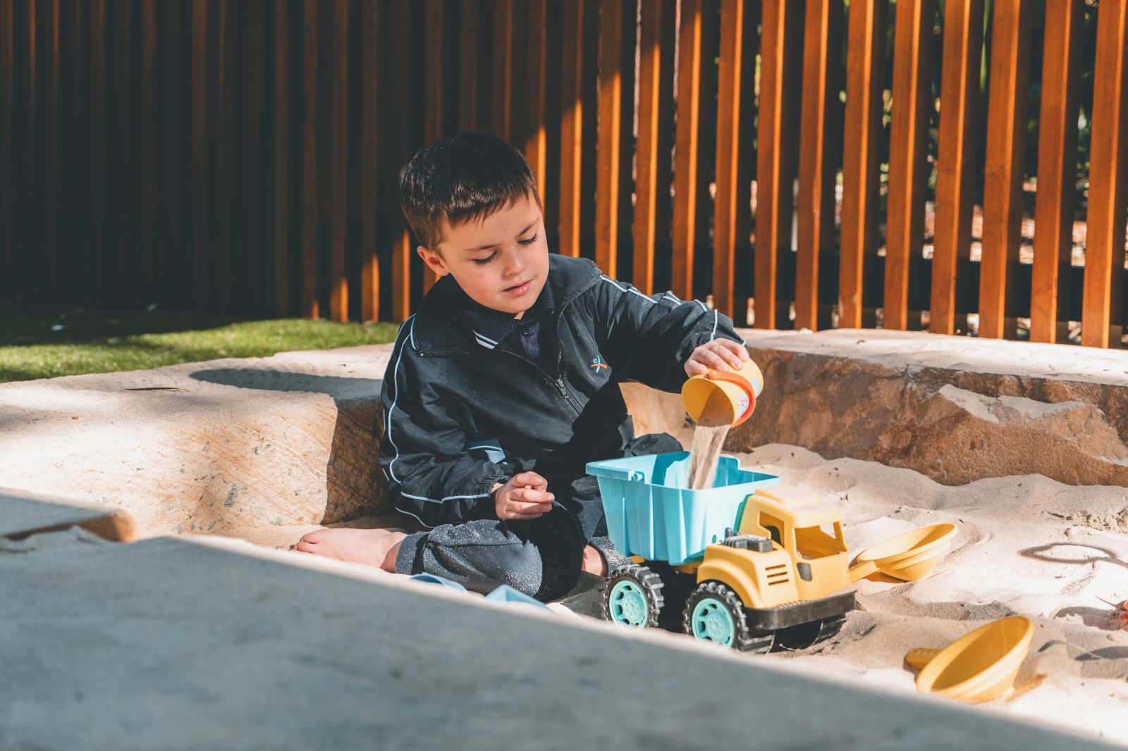 Student playing in sandpit